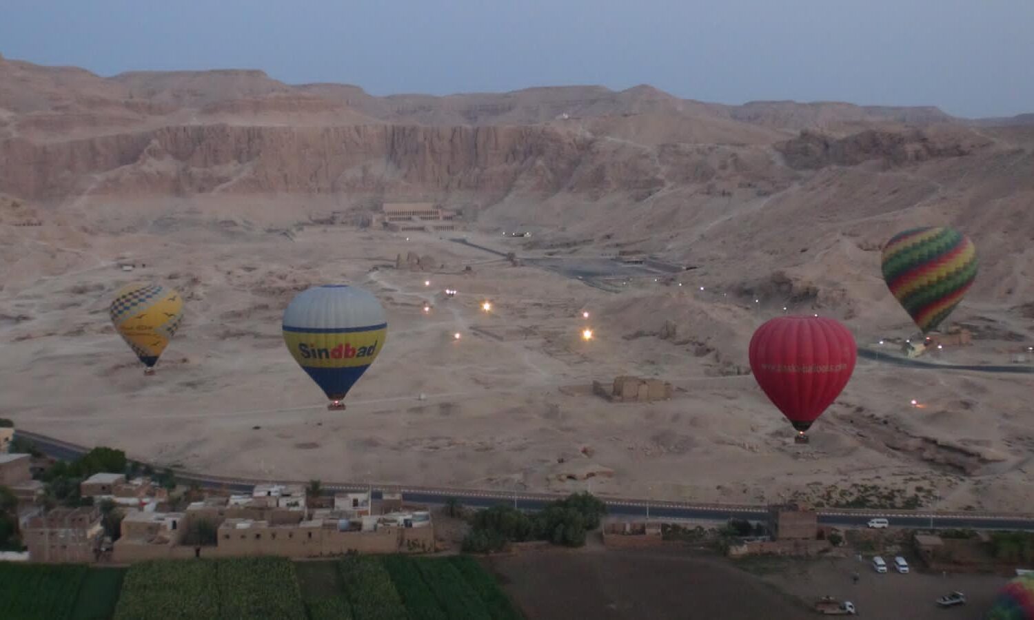 Colorful hot air balloons over the Nile River at sunrise in Luxor, Egypt.